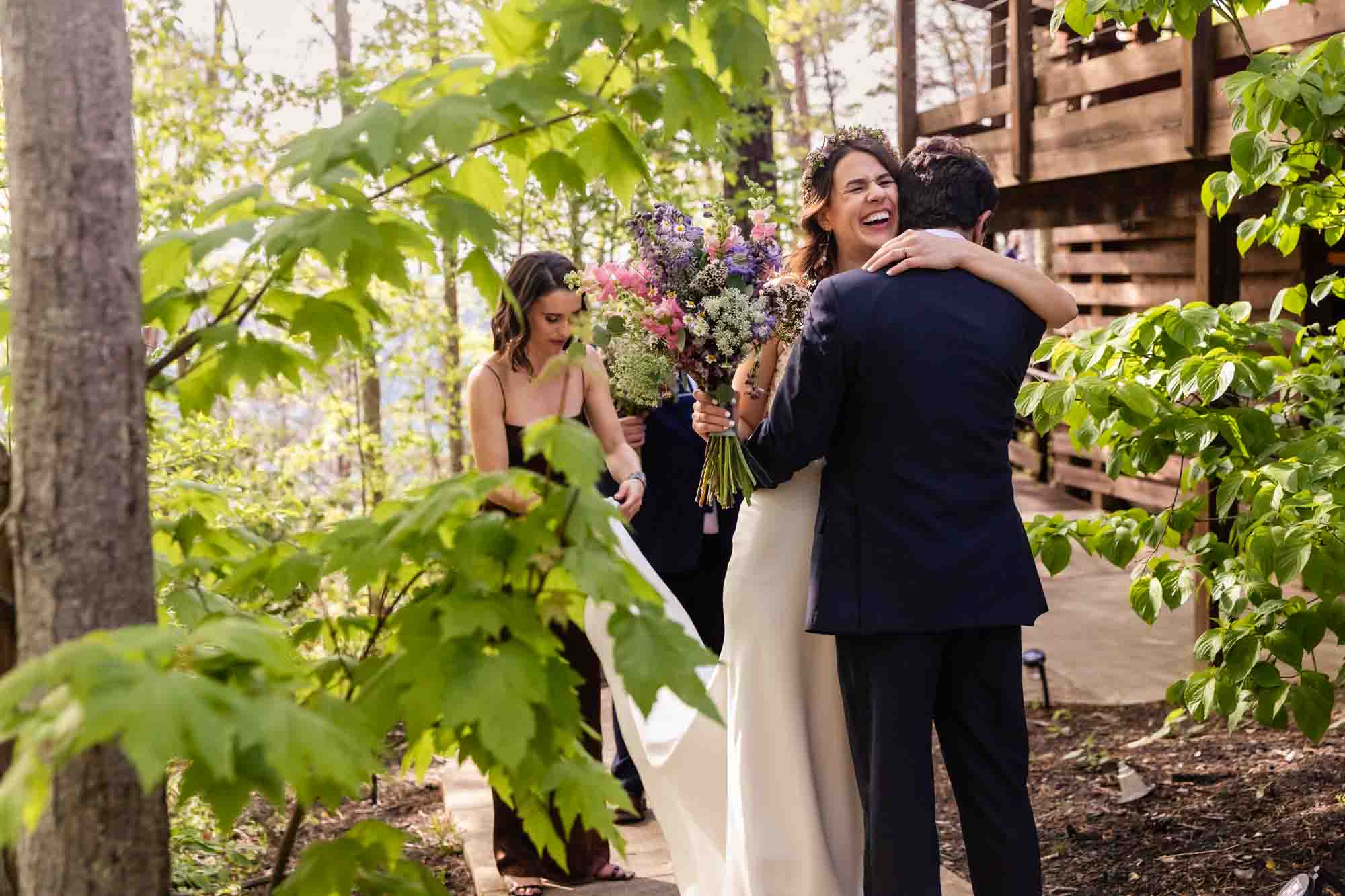 bride and groom hug and share a moment after their wedding ceremony, a moment that a photojournalist who photographs weddings is always looking for